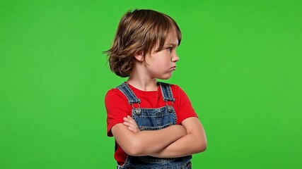 A young boy with an angry expression and crossed arms against a green screen  background, expressing frustration and defiance in a modern style