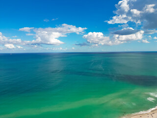Sea on blue sky with clouds. Sea coastal in Miami, aerial view. Sea beach. Sea pier. Beauty shoreline.