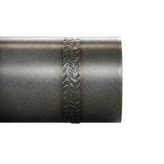 Close-up view of a metal pipe's weld exhibiting a distinctive, wavy pattern.