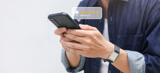 close up young man hand use smartphone to give a rating five star review (best ranking score) on website to share another guest or customer for satisfaction service and lifestyle people concept