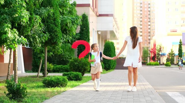 back to school, mother meets or sees off a student at school, September 1, mother takes her daughter to school, beginning of the school year