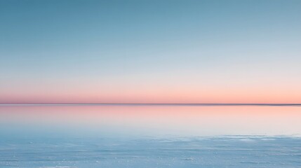 Obraz premium A smooth frozen lake horizon with pale ice tones reflecting a pastel twilight sky