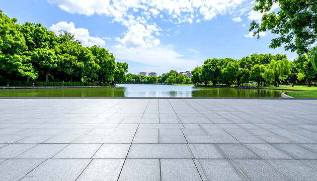 Serene park pond, expansive stone plaza, lush green trees, bright summer sky; tranquil outdoor scene, perfect for design projects.