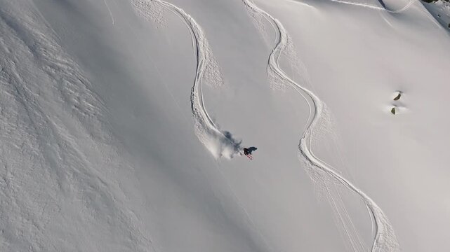 Professional skier making turns on a snowy slope