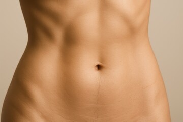 Naklejka premium Serene Close-Up of Toned Female Abdomen in Soft Light