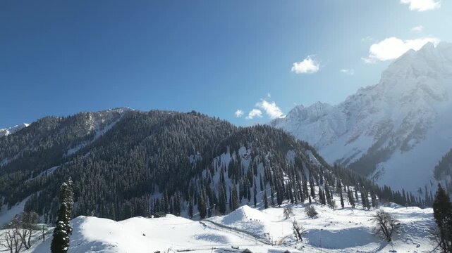 Wide landscape view of snow-covered mountains and valleys in Sonmarg, Kashmir, highlighting the untouched winter charm.