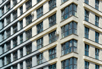Building stands tall in urban district. Modern concrete highrise architecture features patterned