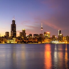 Obraz premium City skyline at sunset with glowing lights and dramatic sky