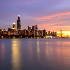 Fototapeta premium City skyline at sunset with glowing lights and dramatic sky