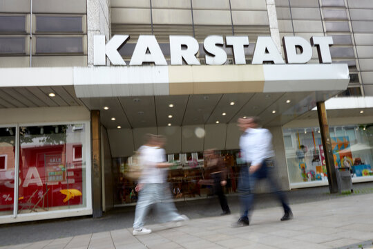 Braunschweig, Lower Saxony, Germany 2025 07 23, Main entrance of a Karstadt department store with blurred people in front of the entrance