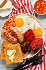 TRADITIONAL ENGLISH BREAKFAST WITH BUTTERED TOAST.TOP VEIW
