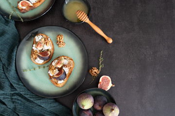 Rustic Fig and Goat Cheese Toast with Honey Bowl on Green Plate