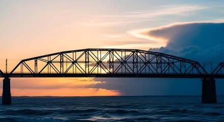 Fototapeta premium Wide shot of a steel truss bridge silhouetted against a pastel sky