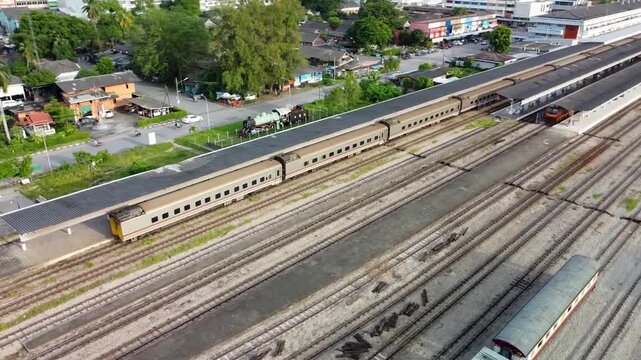 Drone Curved Orbit Over Train at Hat Yai Railway Station Thailand