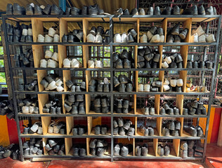 Shoes of people praying in a rack.