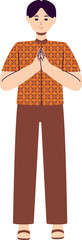 A man in an orange patterned shirt is giving a respectful greeting with hands clasped together.