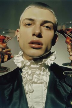 Decadent high-fashion man in a jabot surrounded by cocktail glasses