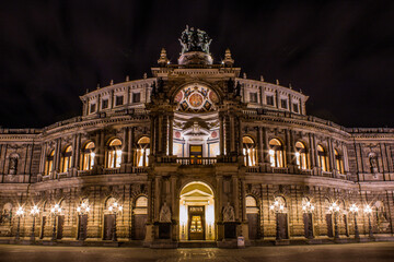 Illuminated historic opera house at night in Dresden, Germany.