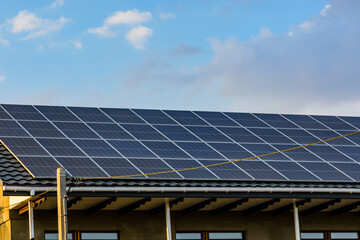 Naklejka premium Solar panels on roof of residential house. Clean energy. Ecological concept