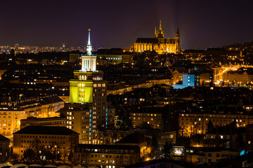 Naklejka premium Night view of Prague, Czech Republic, with illuminated Prague Castle and the Church of St. Vitus in the background.