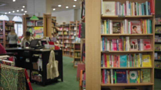 Blurred view of an indoor library with bookshelves filled with colorful books, highlighting a woman browsing in the background, creating a cozy and academic atmosphere.