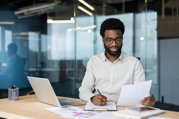 Professional man reviewing documents in a modern office during a work session