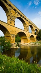 Fototapeta premium Ancient stone bridge over a river