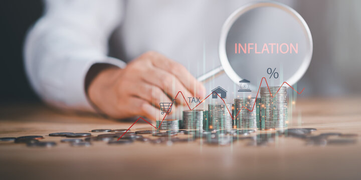 Inflation and economic impact concept showing stacked coins with tax, shopping, housing, and interest icons under magnifying glass, symbolizing cost of living, market changes, and financial burden. - Powered by Adobe