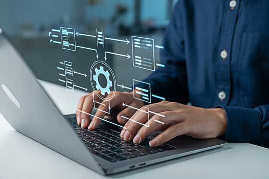 Automation software development process engineer working on laptop for workflow optimization task flow diagram