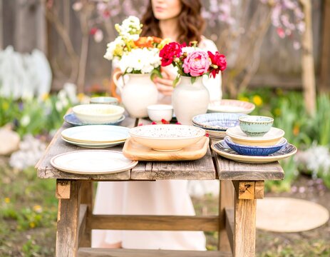 Outdoor dining table setting with flowers - Powered by Adobe