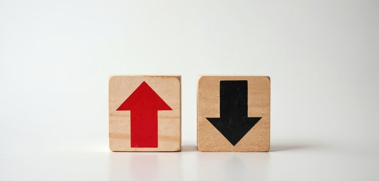 Wooden blocks show opposing directional arrows, contrasting trends choices. One block features red up arrow, black down arrow, representing progress, decline. Symbols convey concepts of decision
