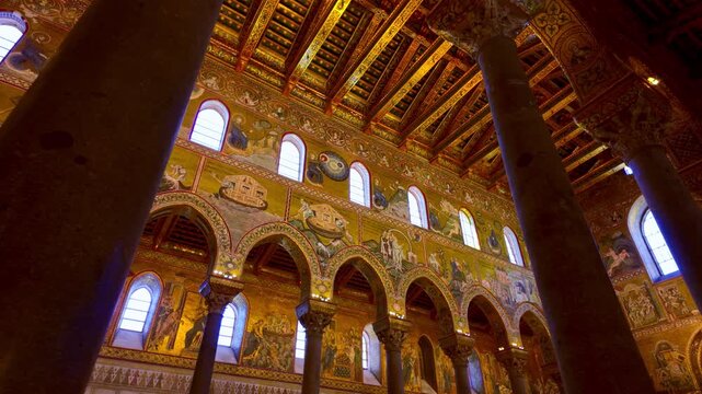 Central nave of the Cathedral of Monreale, Sicily, Italy. Interior view of the Norman-Arab monument with golden mosaics and medieval decorations.
