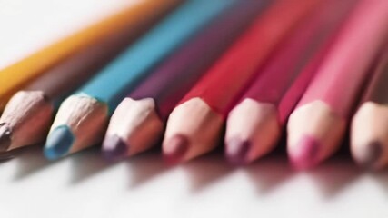 Row of sharpened colored pencils lined up symmetrically, shallow depth of field. - Powered by Adobe