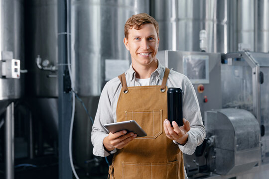 Caucasian male adult brewer with tablet and can, business owner of craft brewery - Powered by Adobe