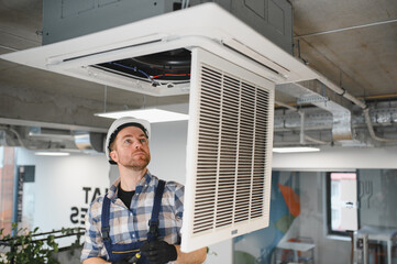 Hvac technician installing air conditioning ventilation system