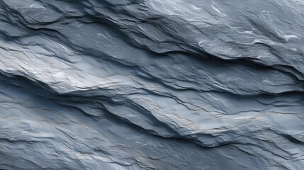 Textured gray rock surface with intricate wave patterns captured in natural light