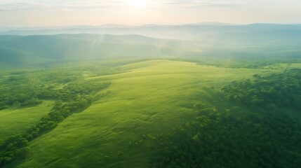 Serene green rolling hills under a hazy sky