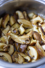 Close-up of shiitake mushrooms being chopped and cooked Thai style