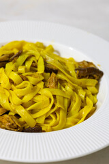 Creamy mushroom and fish Mediterranean Italian Tagliatelle Pasta close up	