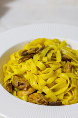 Creamy mushroom and fish Mediterranean Italian Tagliatelle Pasta close up	