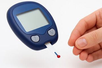 Glucometer and hand checking blood sugar levels with test strip. concept of diabetes management, blood glucose monitoring, health awareness