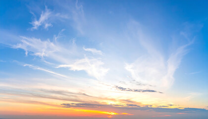 Serene Sunset Sky:  Warm Hues, Wispy Clouds, Peaceful Panorama,  Tranquil Atmosphere,  Golden Hour Light.