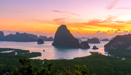 Serene Sunset over Tropical Bay: Panoramic View of Limestone Cliffs, Lush Mangroves, and Calm Waters at Golden Hour.