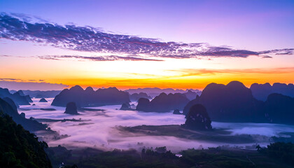 Serene Sunrise over Misty Mountains: Vibrant Purple and Orange Sky, Dramatic Silhouette Landscape Photography.