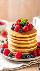 Stack of pancakes topped with fresh berries and mint (1)