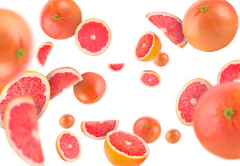 Fresh grapefruits swirling in air against white background