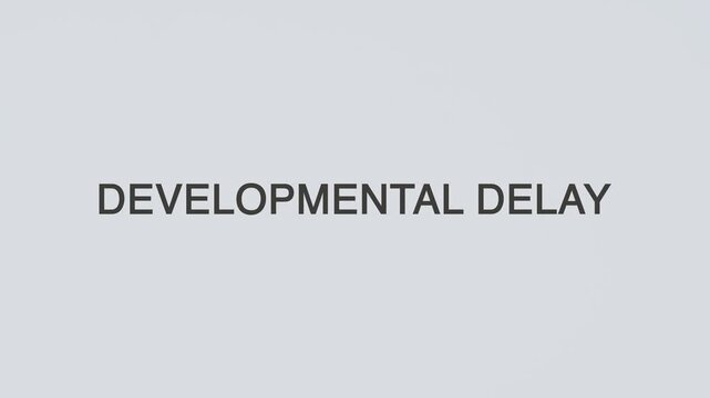 Developmental delay word diagnosed with a stethoscope held in hand on a white background, illustrating pediatric growth disorder, medical diagnosis, healthcare concept, and awareness
