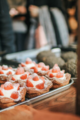 Danish pastry filled with cream, strawberries, prinking of icing sugar. Delicious homemade small cakes