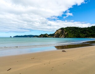 Peaceful beach scene with calm water and hills