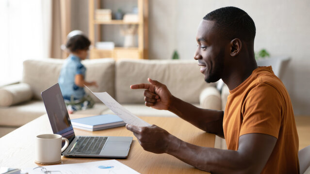 Remote working father at home, digital nomad lifestyle with kids, home office setup, multitasking parent, work from home scene, online job with child, flexible career, parenting workspace - Powered by Adobe